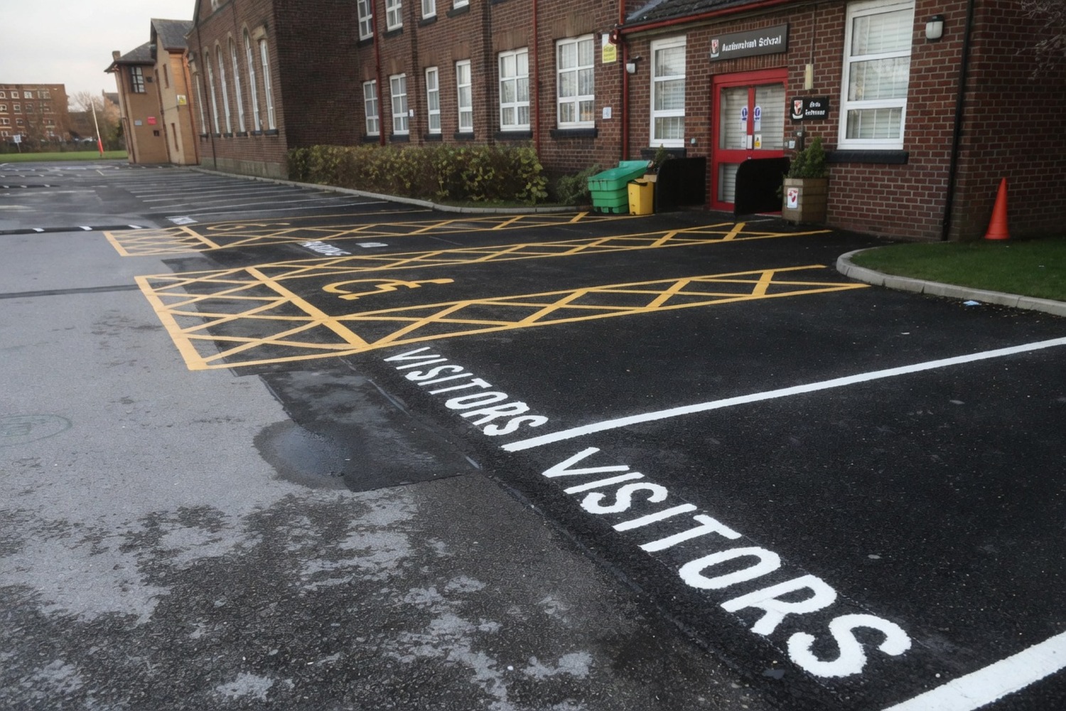 School visitor bay with disabled access markings on commercial paving