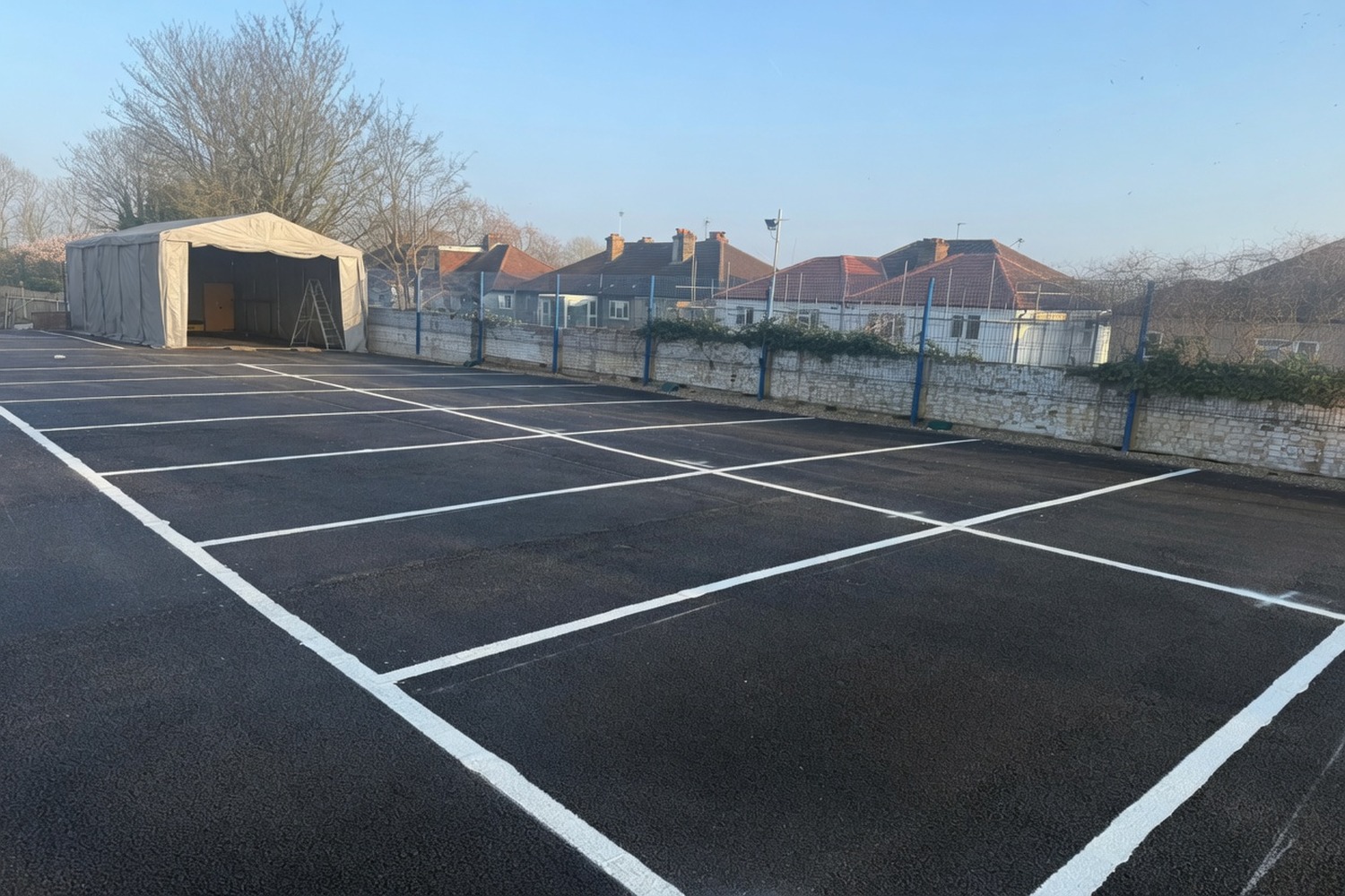 Empty newly-marked car park with event tent in the background