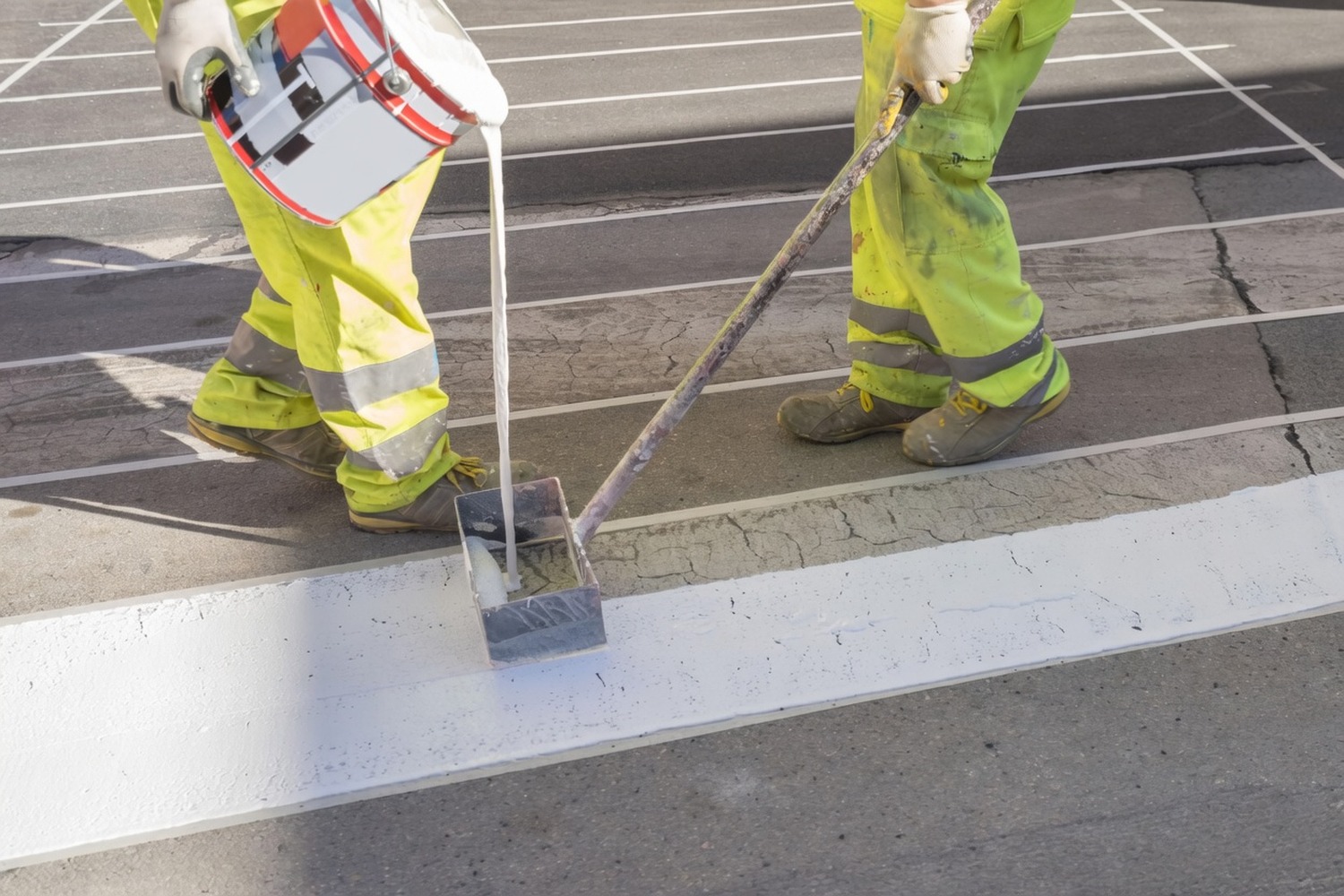 Operative applying a white continuous line on a carriageway